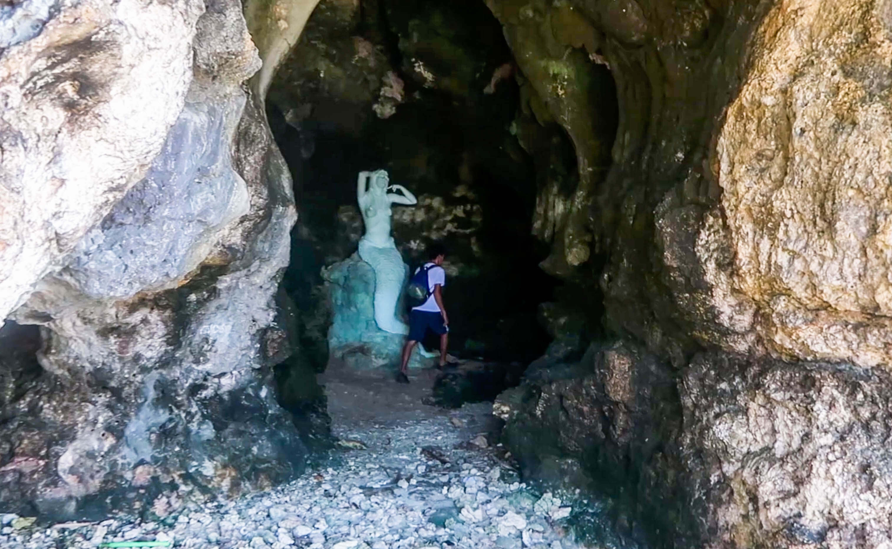 statue of mermaid in little cave on virgin island in hundred islands nature park in pangasinan philippines